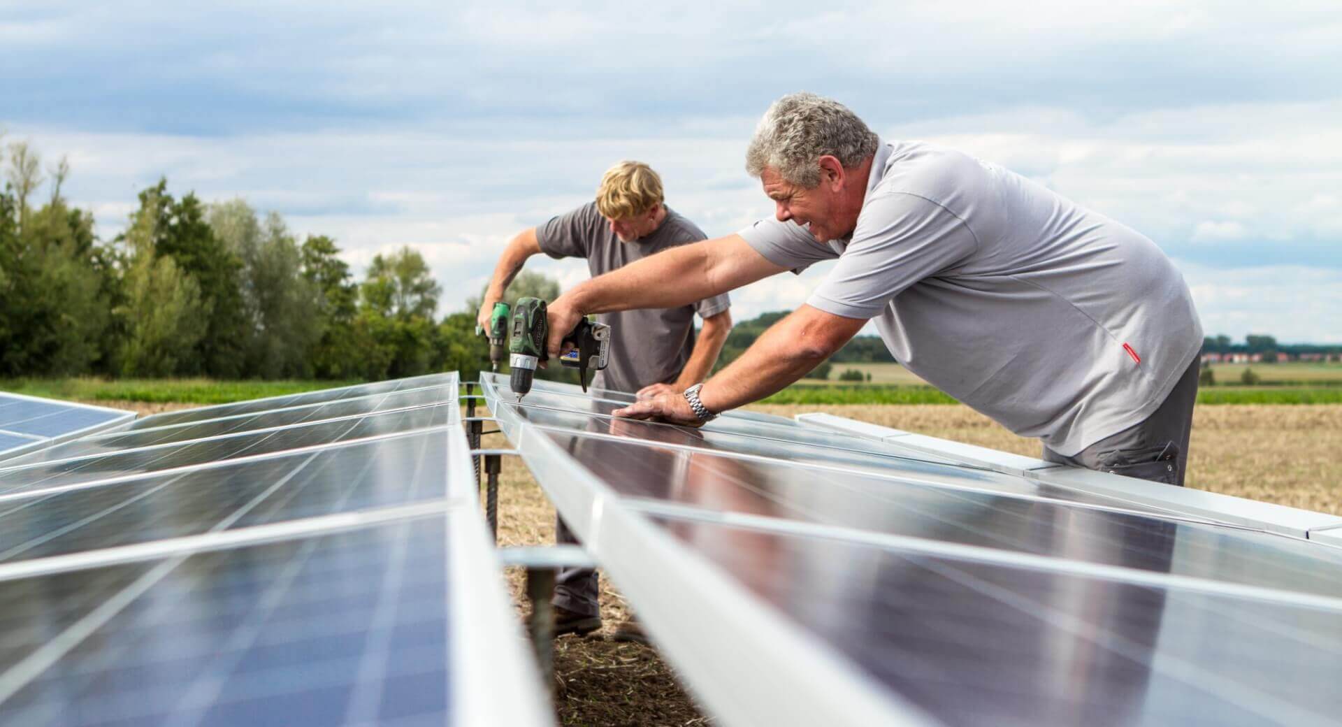 Two Moneutre employees installing PV systems