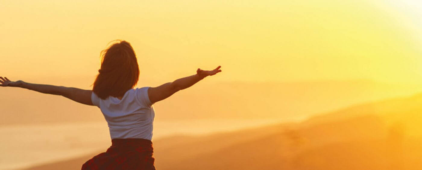 Woman in front of sunset