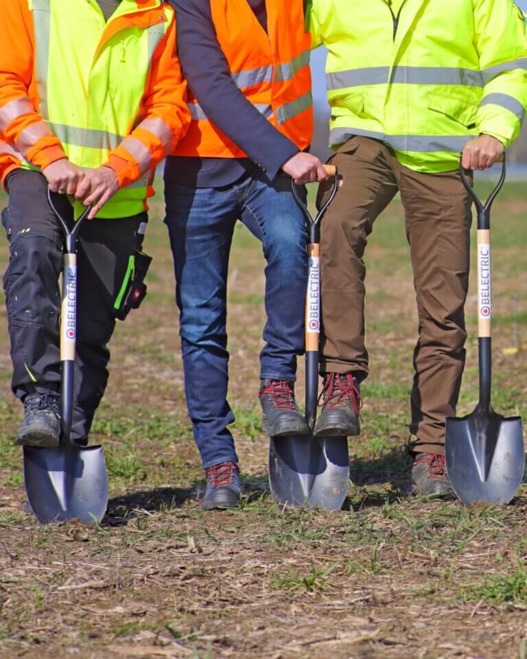 Three people preparing to break ground
