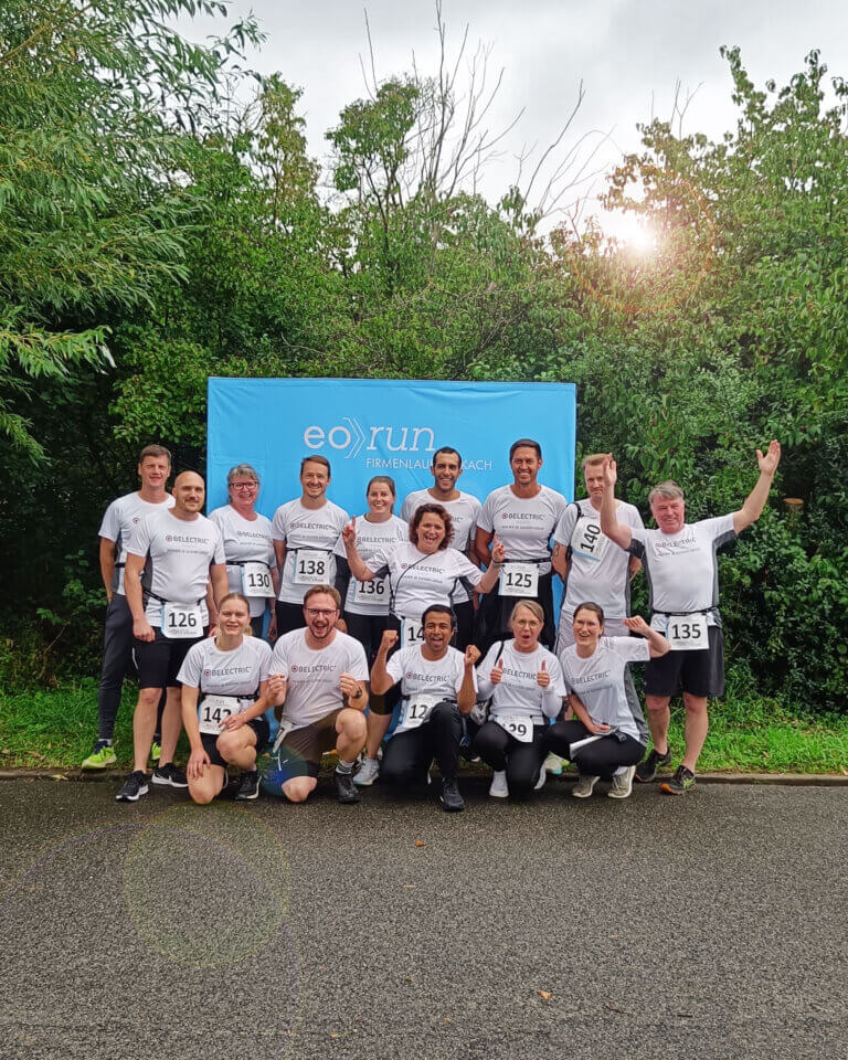a group picture of employees in white sports shirts